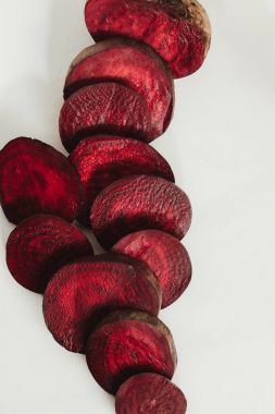 top view of red sliced beetroot on grey clipart
