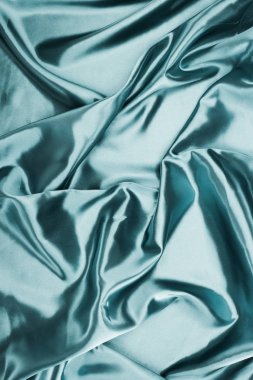 turquoise shiny crumpled satin fabric background