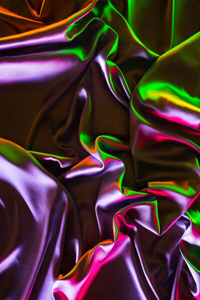 green, violet and pink shiny silk fabric background