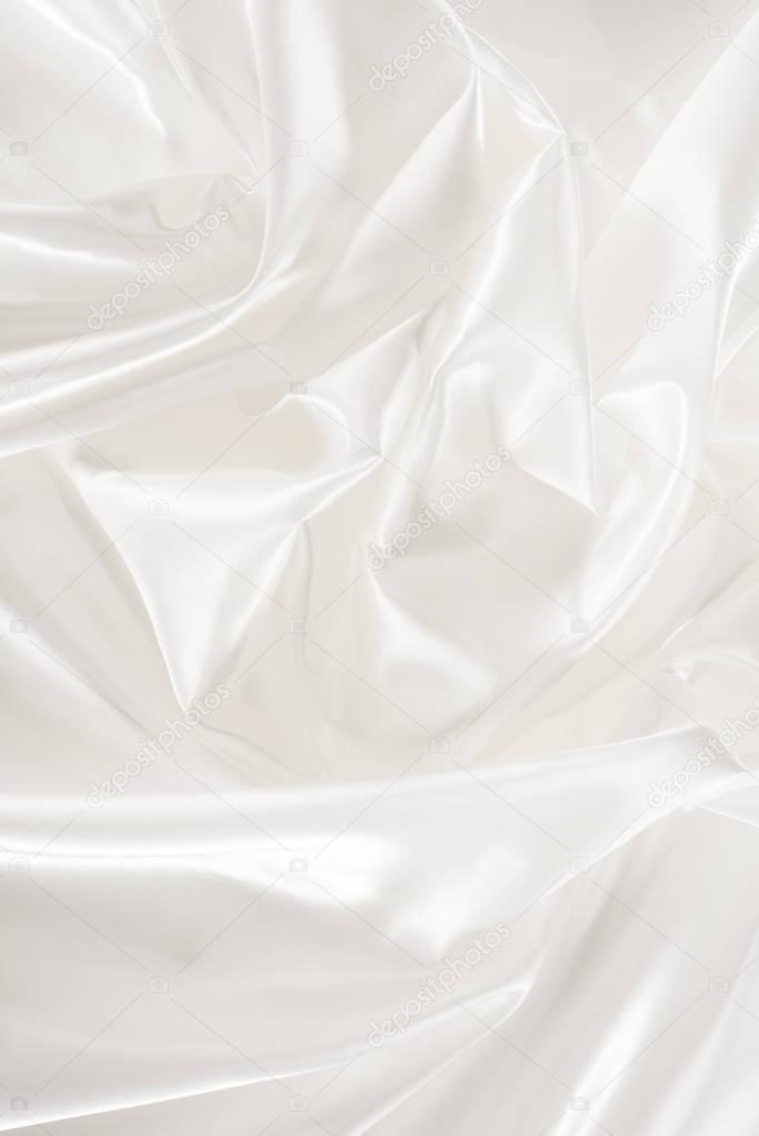 white crumpled shiny silk fabric background