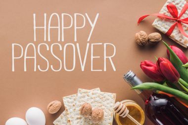 top view of happy passover greeting and matza on brown, Passover Tale concept clipart