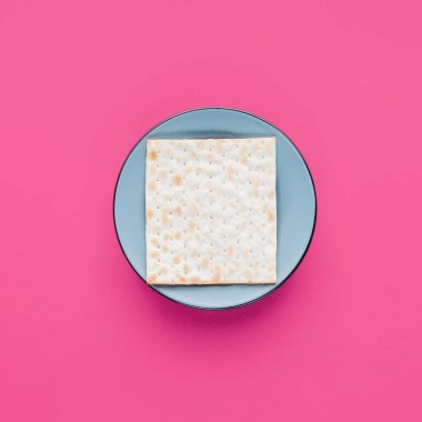 top view of plate with matza isolated on pink, Passover Tale concept clipart