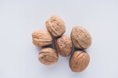 Top view of six walnuts on white surface clipart