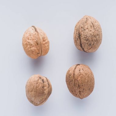 Top view of walnuts on white surface clipart