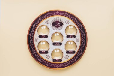top view of traditional jewish plate isolated on beige, Passover Haggadah concept clipart