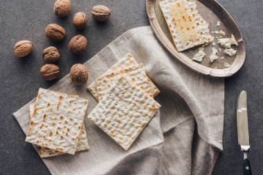 top view of matza and walnuts on concrete table, jewish Passover holiday concept clipart