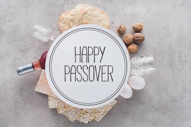 top view of matza and plate with happy passover greeting, jewish Passover holiday concept clipart