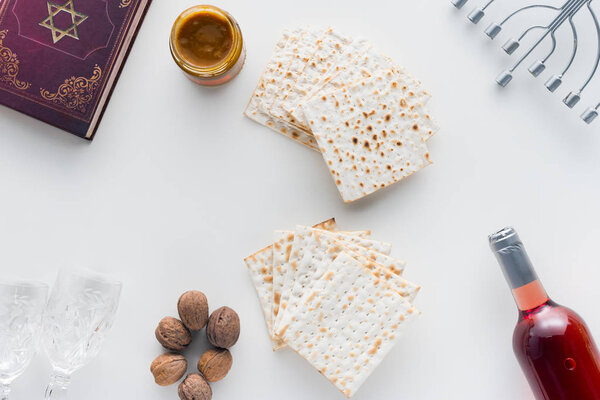 top view of matza and torah on white surface, Pesah celebration concept