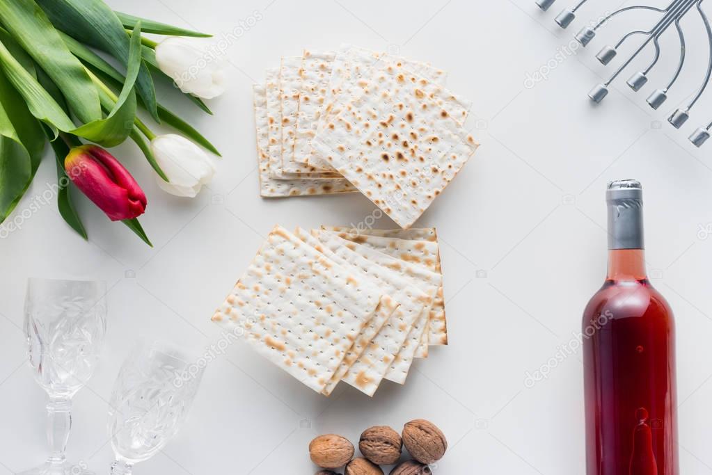 top view of matza and wine with flowers, jewish Passover holiday concept