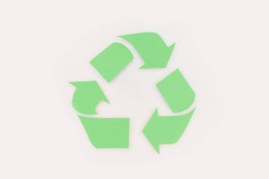 top view of green arrows recycle sign on white clipart