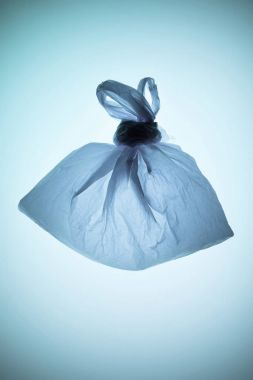 tied transparent plastic bag under blue toned light clipart