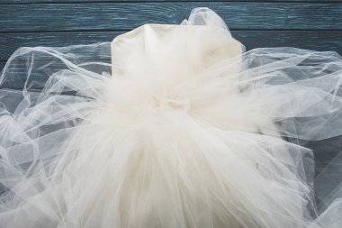top view of wedding dress on wooden dark blue tabletop clipart