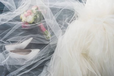 çift ayakkabı, gelinlik ve gelin buketi üstten görünüm üzerinde ahşap koyu mavi masa üstü
