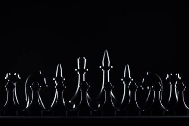 silhouettes of chess figures isolated on black, business concept clipart