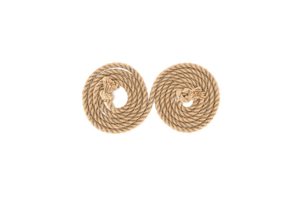 top view of arranged brown marine rope with knots isolated on white