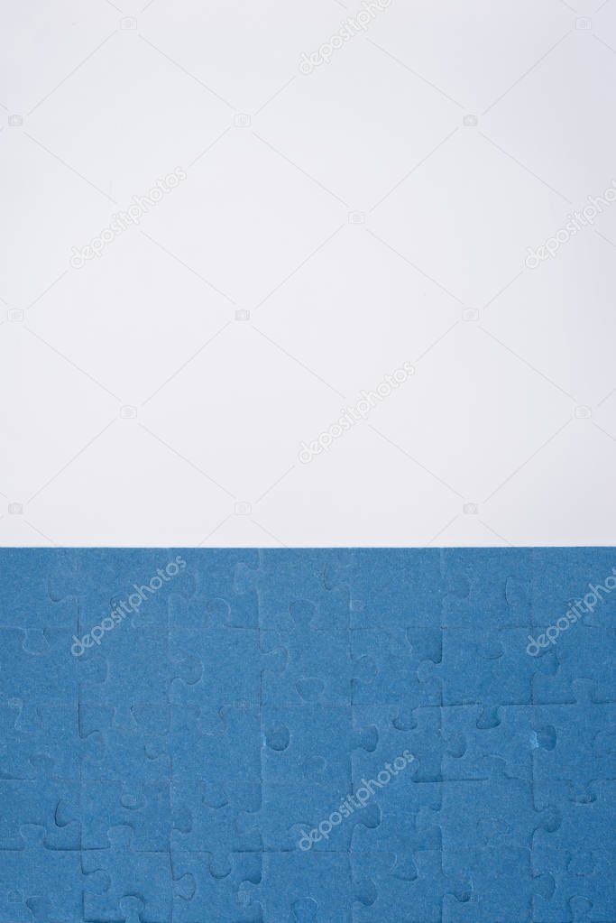 top view of blue assembled puzzles isolated on white, business concept