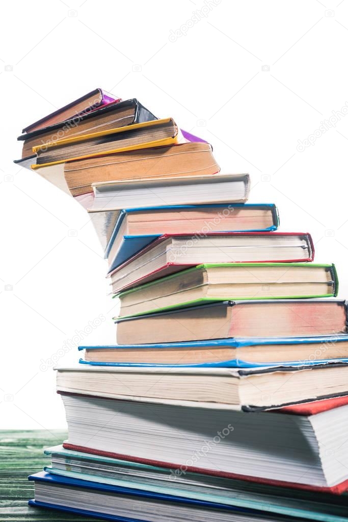 Curved stack of colorful books on table