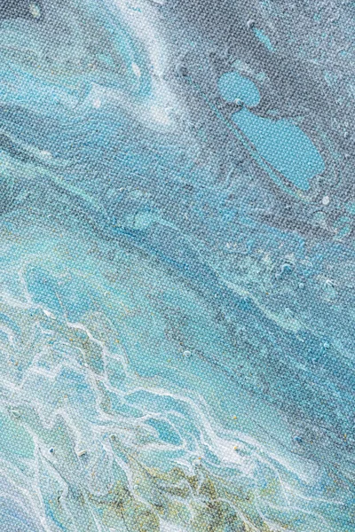 close up of abstract creative background with light blue oil paint 