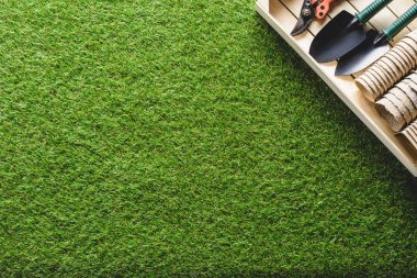 top view of stacks of flower pots and gardening tools on grass clipart