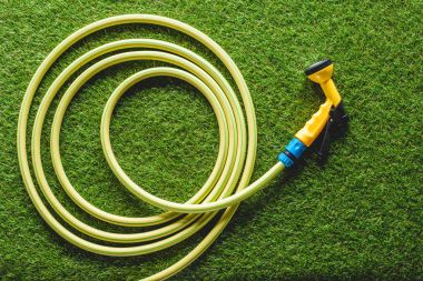 top view of hosepipe on grass, minimalistic conception clipart