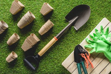 top view of arranged flower pots and gardening equipment on grass clipart