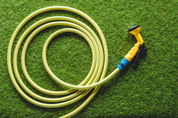 top view of hosepipe on grass, minimalistic conception