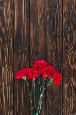 top view of pile of carnations on wooden planks  clipart