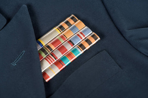 closeup shot of medals on navy blue jacket, victory day concept 