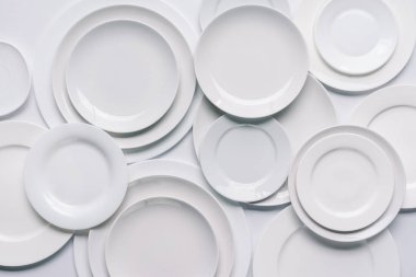 white plates composition on white background clipart