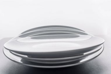 Shiny white kitchen ceramic plates clipart