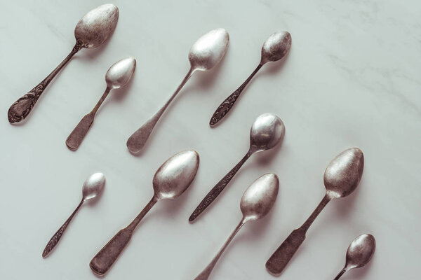 Various vintage spoons on white table