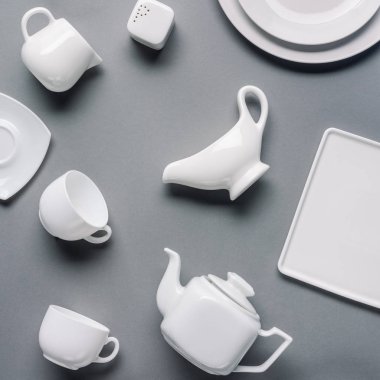 White china tea-set on grey background clipart
