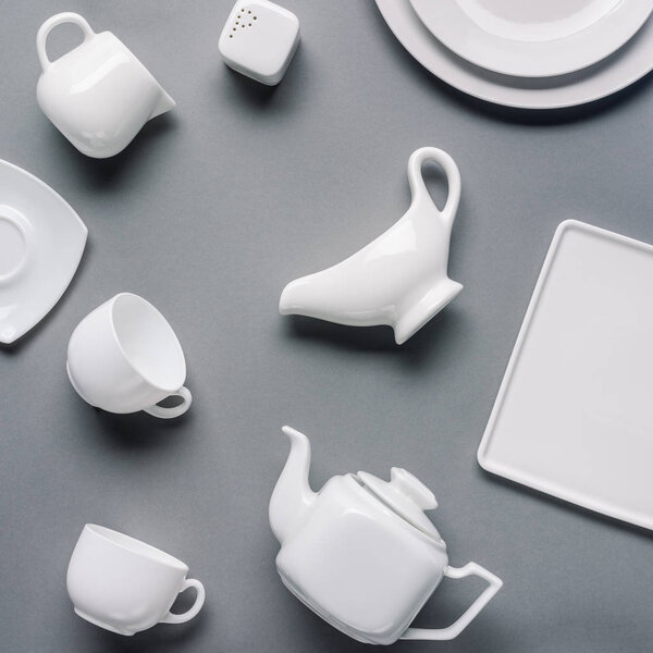 White china tea-set on grey background