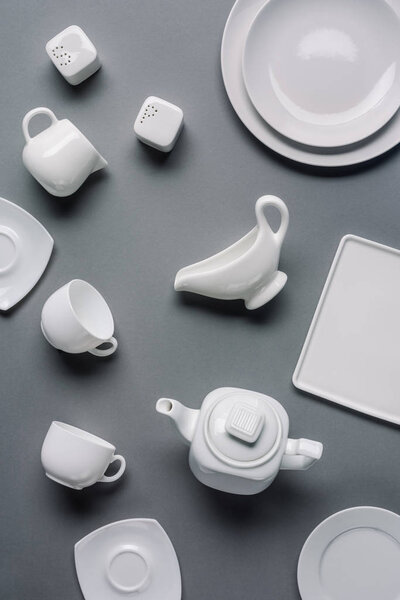 White tableware for dinner and tea time on grey background