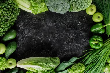 elevated view of green vegetables on concrete tabletop, healthy eating concept clipart