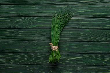 top view of bunch of chives on wooden table, healthy eating concept clipart