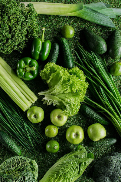 top view of ripe appetizing green vegetables on grass, healthy eating concept