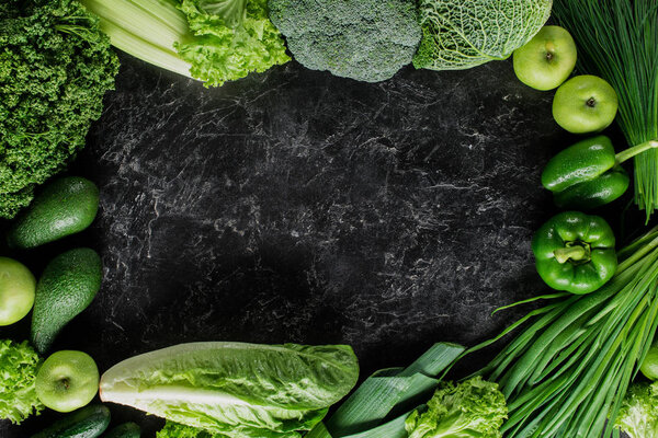 elevated view of green vegetables on concrete tabletop, healthy eating concept