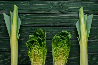 top view of green leek and cabbage on tabletop, healthy eating concept clipart
