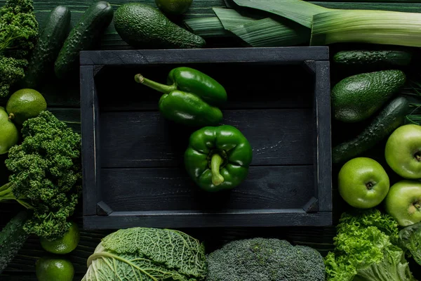 Top view of green bell peppers in wooden box between vegetables, healthy eating concept — Stock Image Top View Green Bell Peppers Wooden Box Vegetables Healthy Eating Royalty Free Stock Images