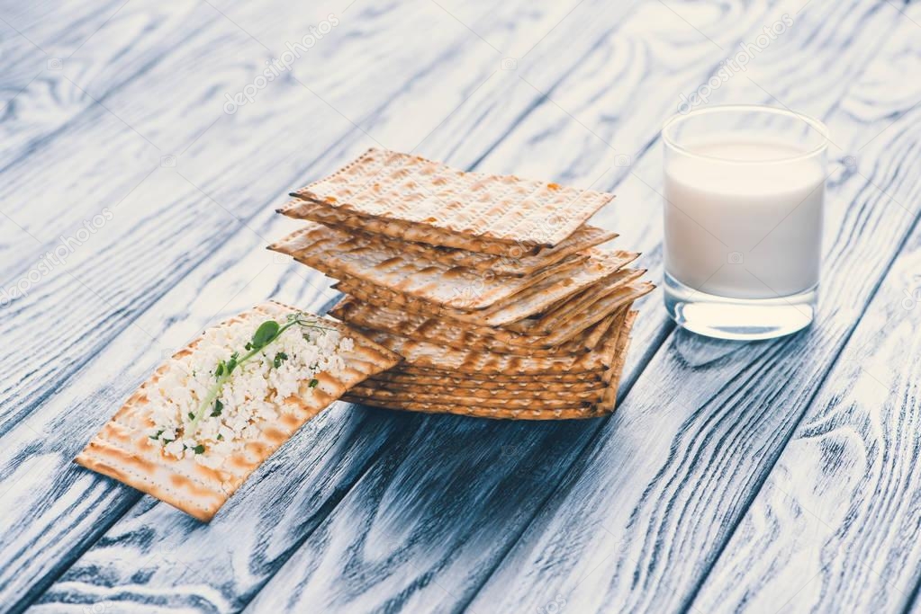 crispy crackers with cottage cheese and glass of milk on wooden table