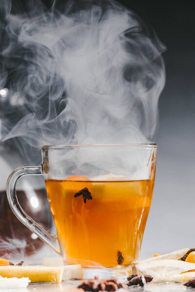 Glass cup of hot steaming tea