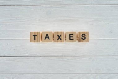 Beyaz ahşap masa üzerinde vergi Word'de düzenlenmiş ahşap blokların Üstten Görünüm