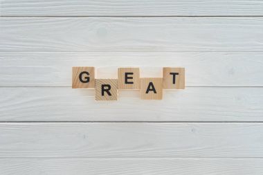 top view of great inscription made of blocks on white wooden tabletop clipart