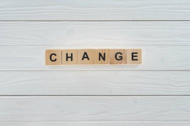 close up view of change word made of wooden cubes on white wooden tabletop  clipart