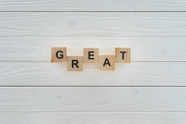 top view of great inscription made of blocks on white wooden tabletop