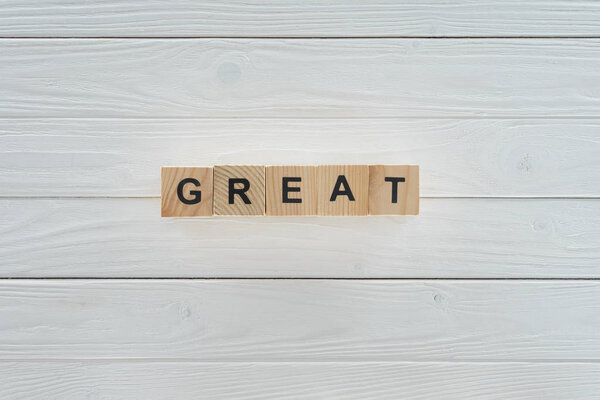 top view of great inscription made of blocks on white wooden tabletop