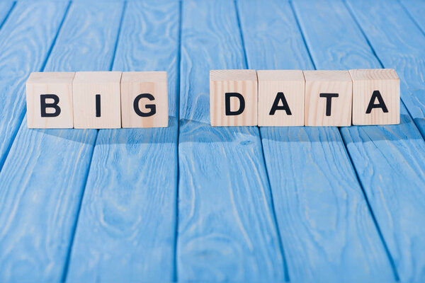 close up view of arranged wooden blocks into big data phrase on blue wooden surface 