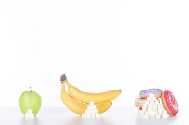 apple, bananas and doughnuts with sugar cubes on white clipart