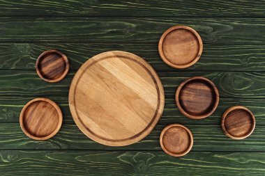 different types of wooden round cutting boards on table  clipart